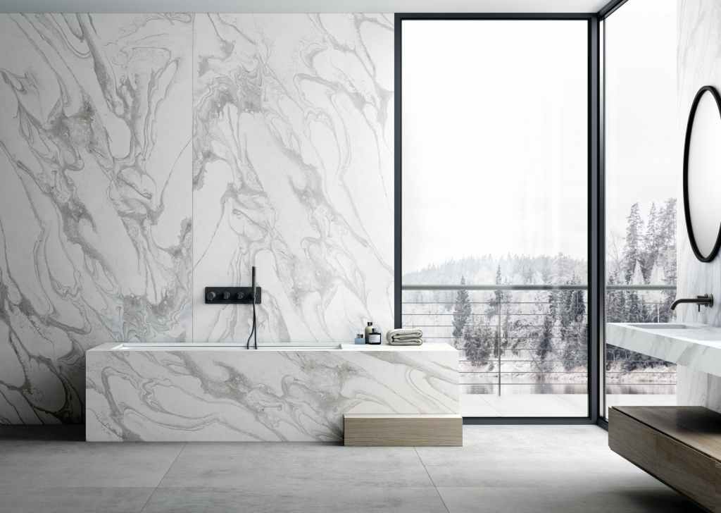 A large bathroom with huge open windows from floor to ceiling. White marble countertops