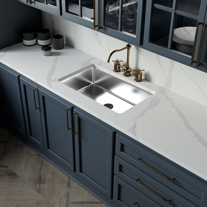 Modern and compact kitchen with a white countertop, greyish blue cabinetry, and a bronze sink